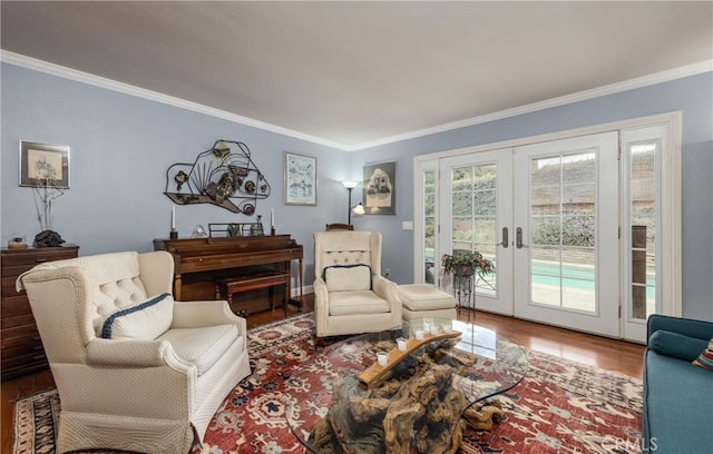 sitting room with wood finished floors, french doors, and ornamental molding