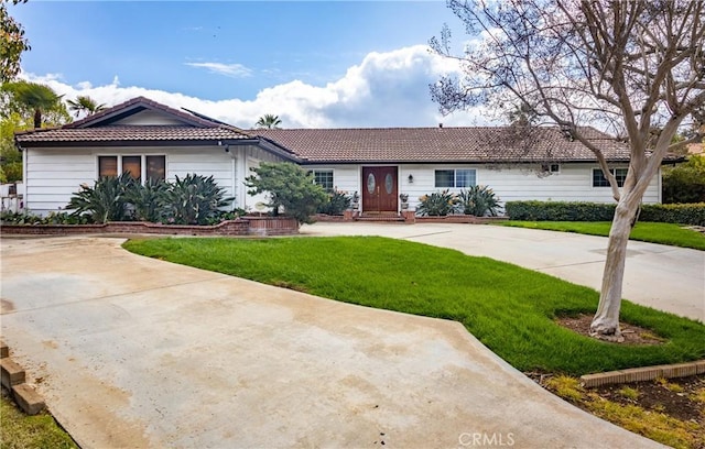 single story home with a tiled roof and a front yard