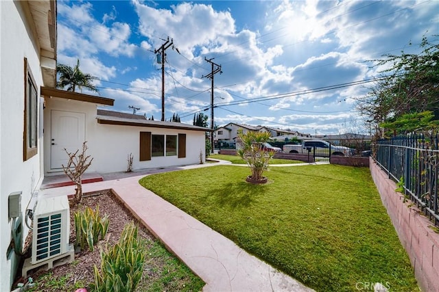 view of yard with ac unit and fence