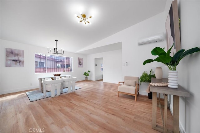 dining room with light wood finished floors, baseboards, vaulted ceiling, an inviting chandelier, and a wall mounted AC