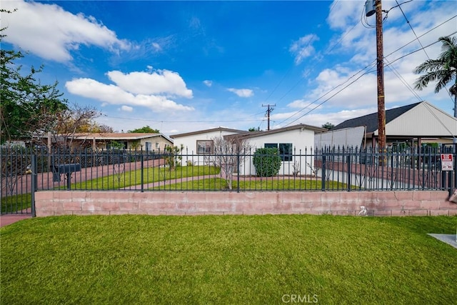 view of front of house with a front yard and a fenced front yard