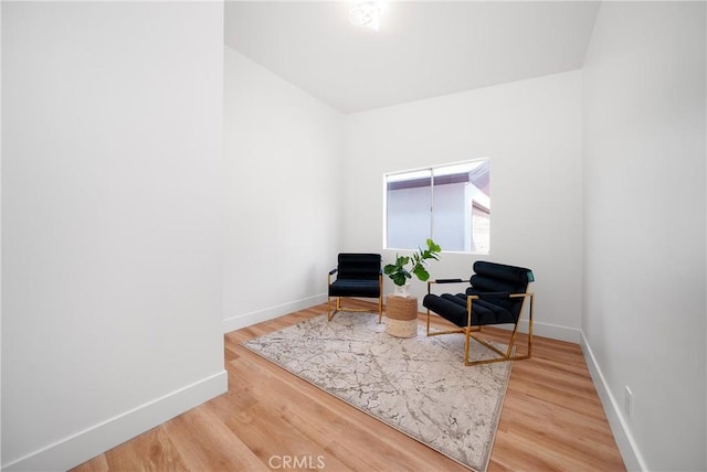 sitting room featuring baseboards and wood finished floors