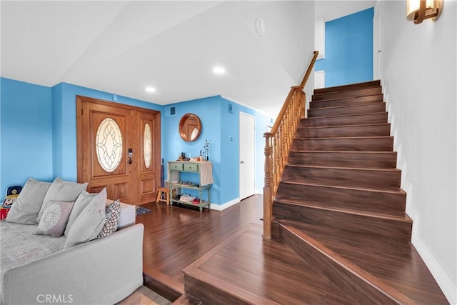 foyer with visible vents, wood finished floors, recessed lighting, stairway, and baseboards