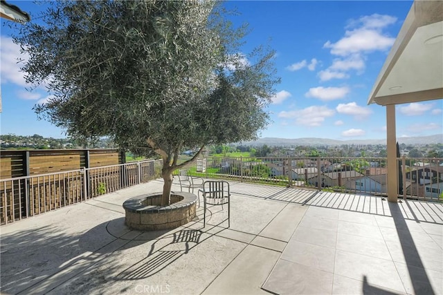 view of patio featuring a mountain view and an outdoor fire pit