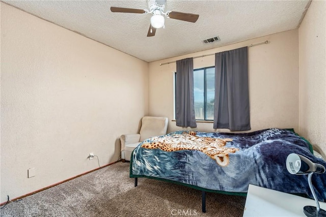 bedroom with visible vents, baseboards, carpet flooring, a textured ceiling, and a ceiling fan