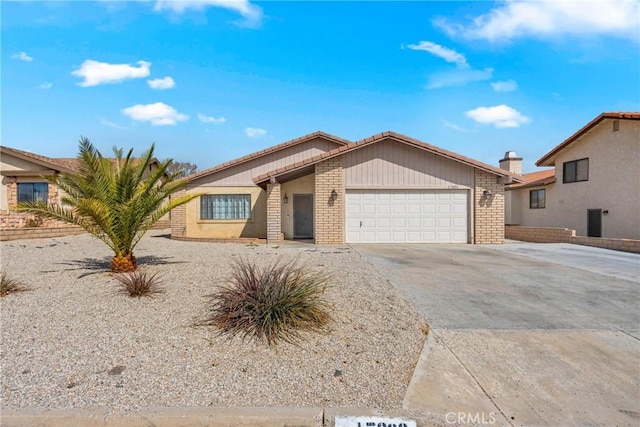 view of front of home featuring brick siding, concrete driveway, and an attached garage