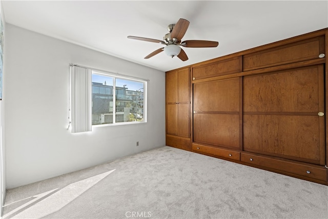 unfurnished bedroom featuring ceiling fan and carpet floors