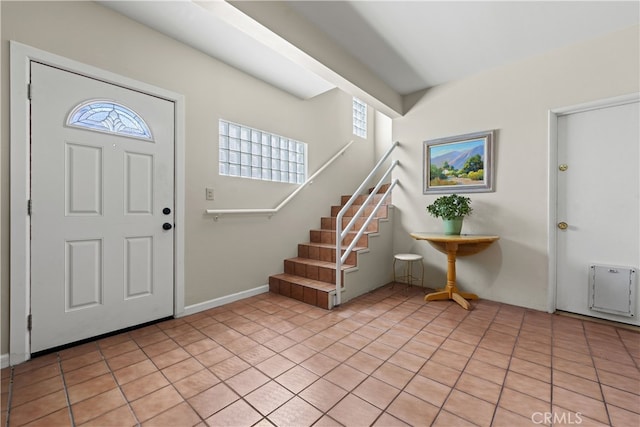 entryway featuring stairway and light tile patterned floors