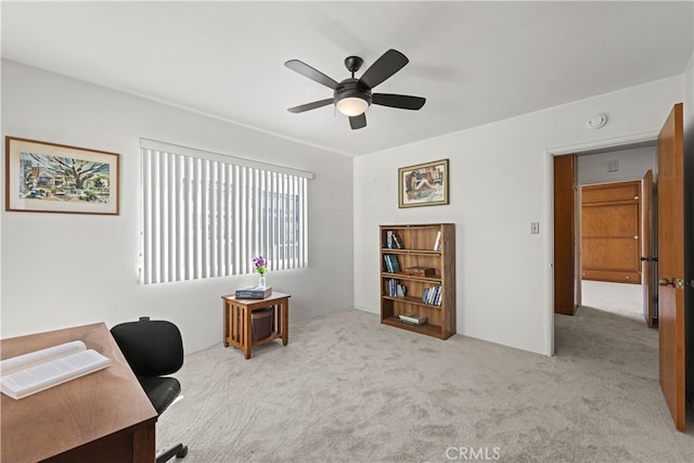 carpeted office featuring a ceiling fan