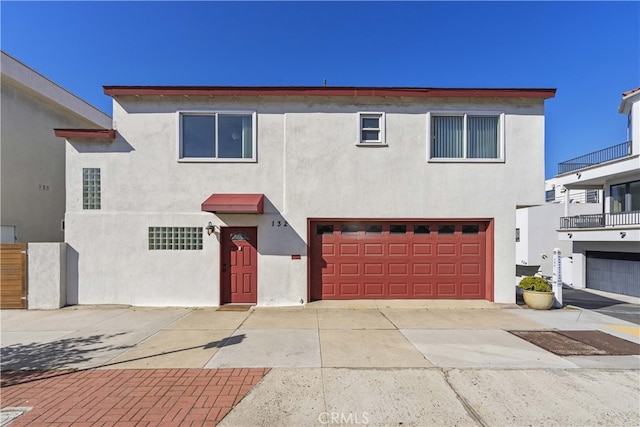 townhome / multi-family property featuring a garage and stucco siding