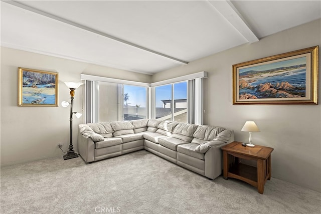 living room featuring beamed ceiling and light colored carpet