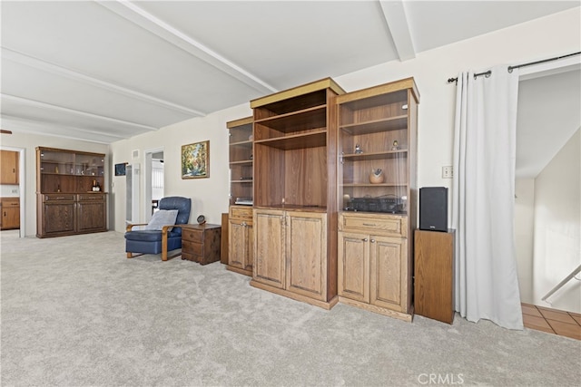 living room with light carpet and beam ceiling