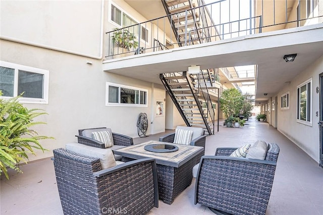 view of patio featuring an outdoor hangout area and stairs