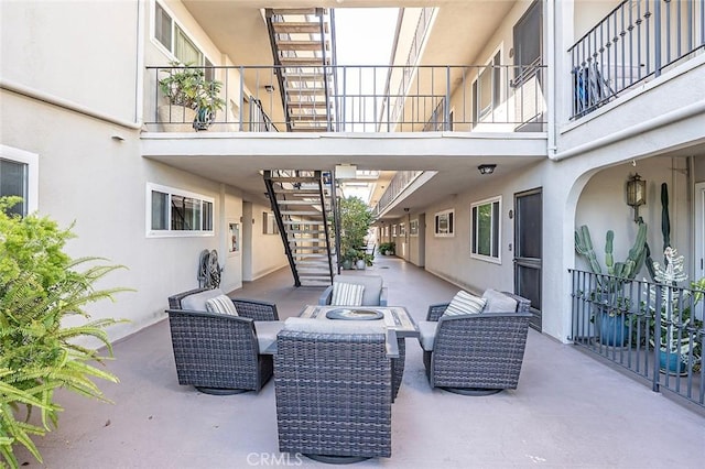 view of patio / terrace featuring stairway and an outdoor hangout area