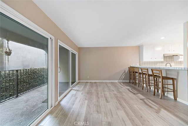 interior space featuring light wood finished floors and baseboards