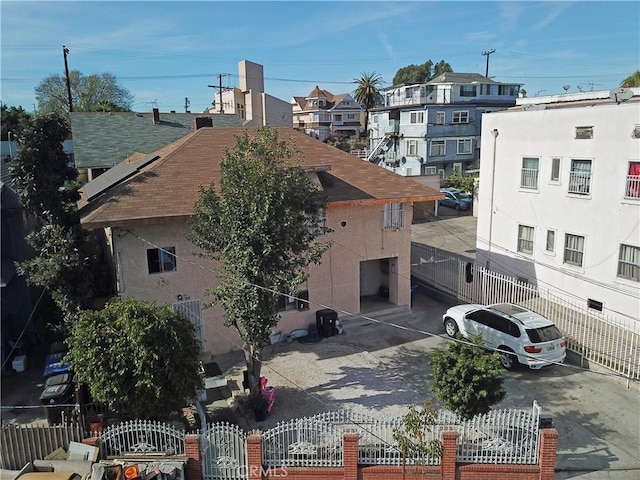 view of building exterior featuring driveway and a fenced front yard