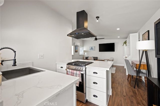 3345 Oakhurst Ave, Los Angeles, CA 90034 - kitchen with island exhaust hood, stainless steel range with gas stovetop, a sink, dark wood-type flooring, and a ceiling fan