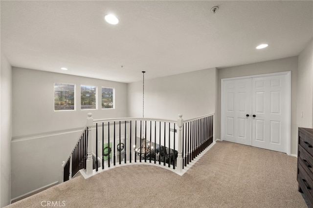 hall featuring recessed lighting, baseboards, and carpet floors