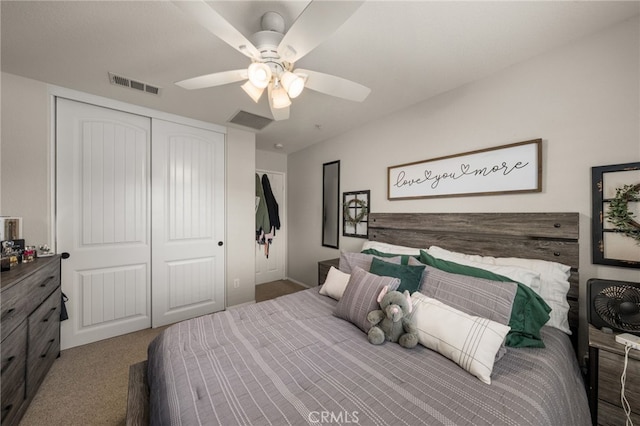 carpeted bedroom featuring a closet, visible vents, and ceiling fan