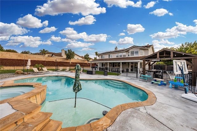 view of pool featuring an in ground hot tub, fence, a patio area, and a fenced in pool