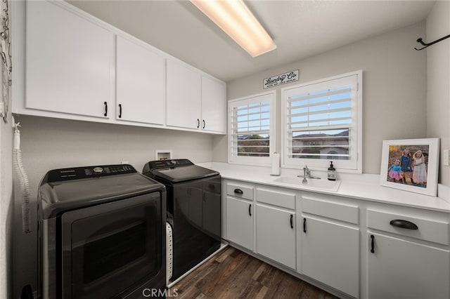 laundry area with separate washer and dryer, dark wood-style floors, cabinet space, and a sink