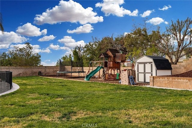 view of play area featuring a yard, a fenced backyard, an outdoor structure, a storage shed, and a trampoline