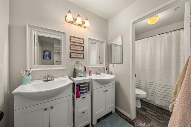 full bath with vanity, toilet, and wood finished floors