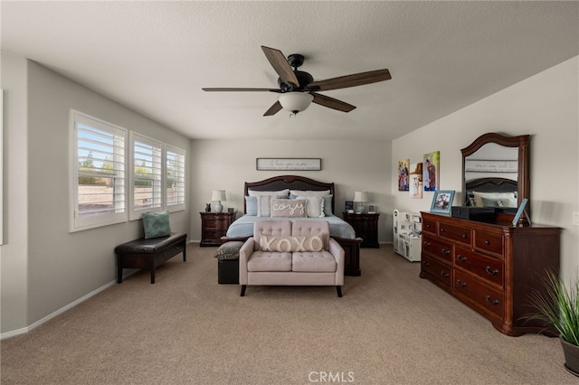 bedroom with baseboards, light colored carpet, a textured ceiling, and ceiling fan