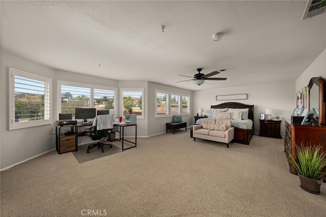 bedroom featuring light carpet, visible vents, a textured ceiling, and baseboards