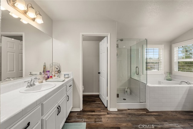 full bathroom featuring vanity, wood finished floors, toilet, a shower stall, and a bath