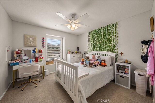 carpeted bedroom featuring baseboards and a ceiling fan