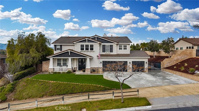 view of front of property featuring a front yard, fence, driveway, stone siding, and a tiled roof