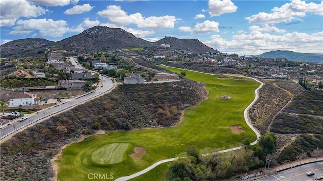 drone / aerial view featuring view of golf course and a mountain view