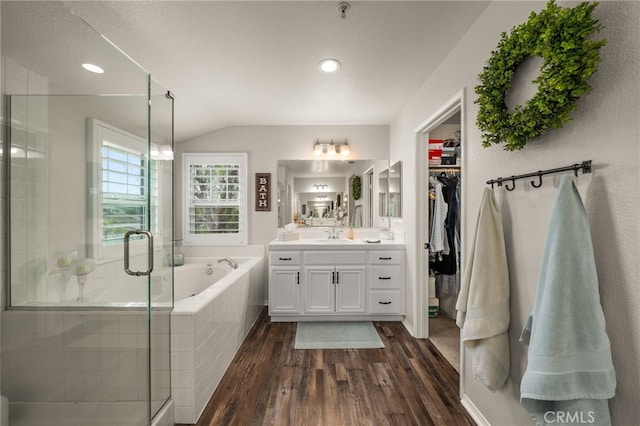 bathroom featuring vanity, a garden tub, wood finished floors, and a stall shower