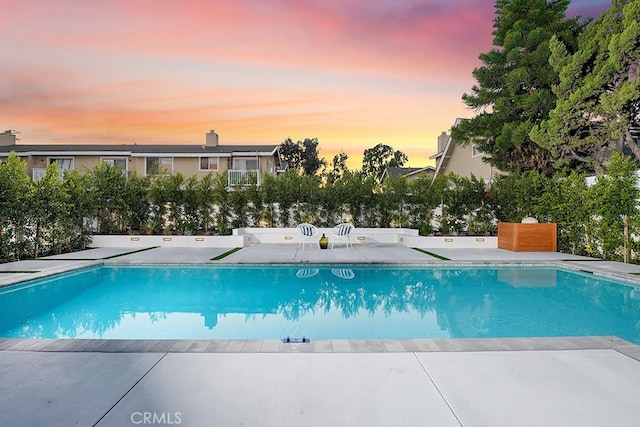 outdoor pool with a patio area