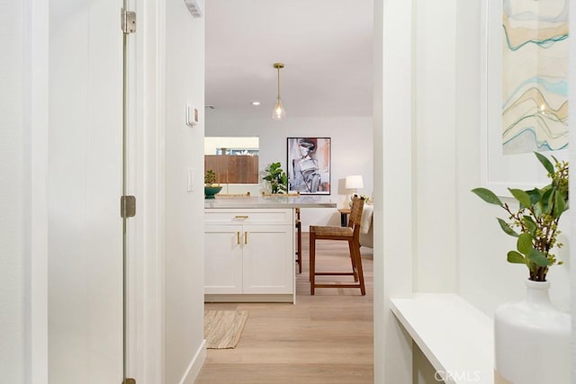 hallway with visible vents and light wood-style flooring