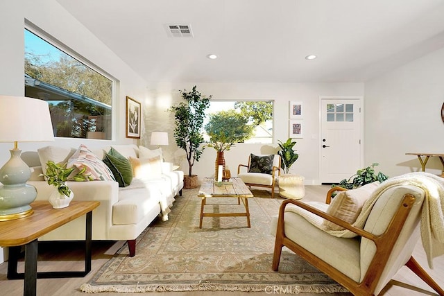 living area featuring visible vents, recessed lighting, and light wood-style flooring