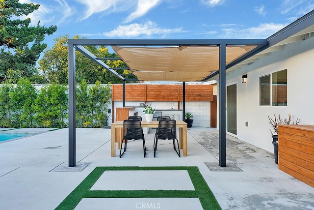 view of patio with outdoor dining space, a pergola, and a fenced backyard