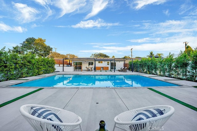 outdoor pool featuring central AC unit and a patio