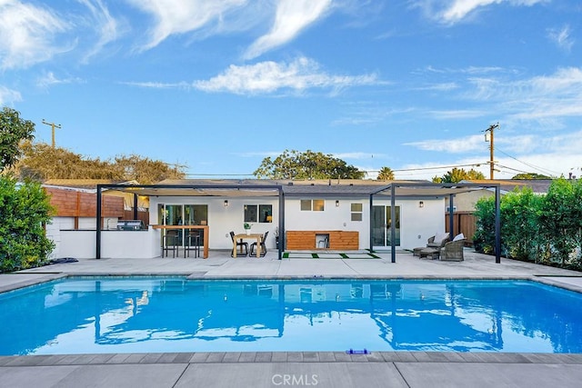 back of house with a patio area, a fenced in pool, and fence