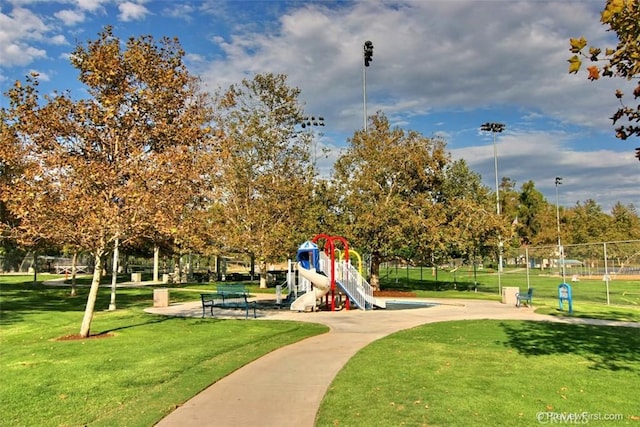 surrounding community featuring playground community, a yard, and fence