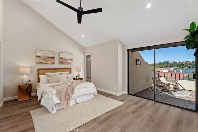 bedroom with high vaulted ceiling, wood finished floors, recessed lighting, baseboards, and access to exterior