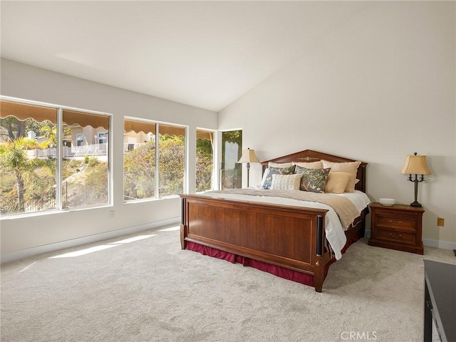 bedroom featuring light carpet and lofted ceiling