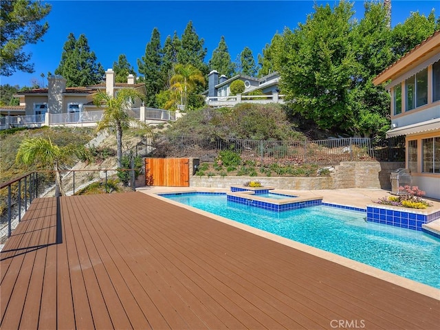 view of pool with an in ground hot tub, fence, a fenced in pool, and a wooden deck