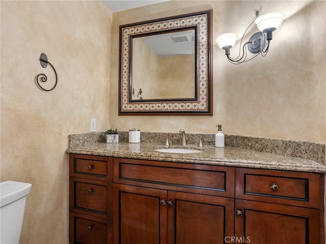 half bathroom with toilet and vanity