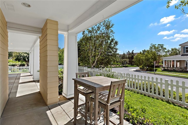 view of patio with visible vents, outdoor dining area, and fence