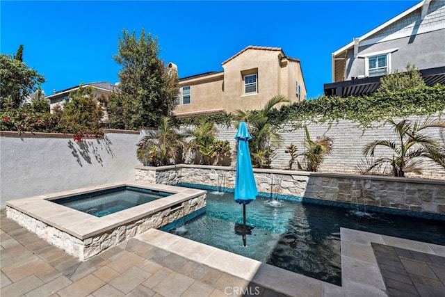 view of pool with an in ground hot tub and a fenced backyard