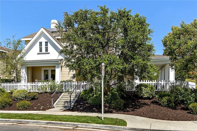 view of front of property featuring a porch and fence