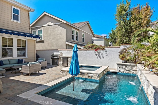 view of pool featuring a patio, exterior kitchen, a pool with connected hot tub, grilling area, and an outdoor hangout area