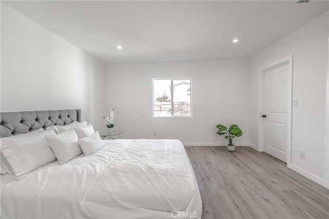 bedroom featuring recessed lighting, baseboards, and light wood-style floors